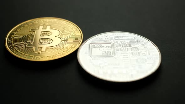 Golden and Silver Bitcoin Coins on Black