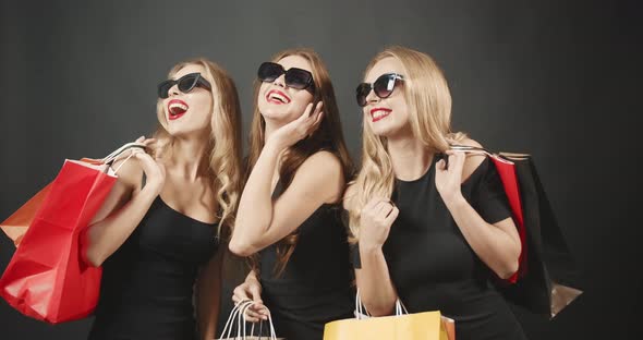 Smiling Women with Shopping Bags