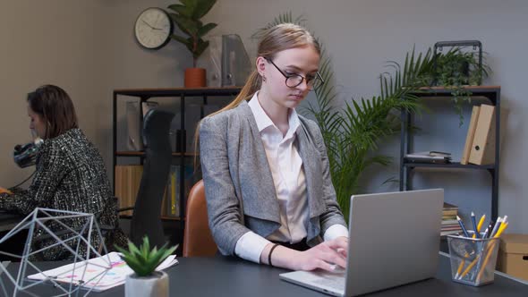 Joyful Business Woman Freelancer Concentrated Developing New Project While Looking on Laptop Screen alt