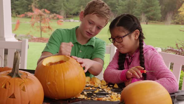 Kids carving pumpkins for Halloween