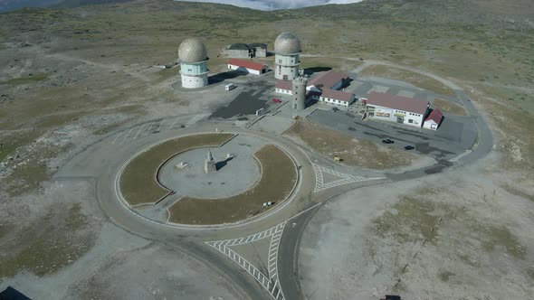 Tower peak pillar and old radome, Serra da Estrela. Aerial top-down circling alt