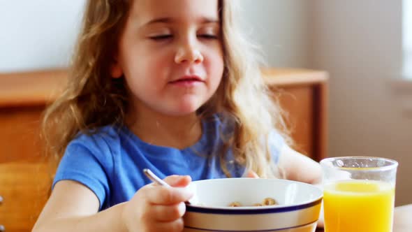 Girl having breakfast at home alt
