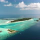 Aerial Video Above Tropical Resorts in Turquoise Lagoon with Water Villas - VideoHive Item for Sale