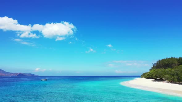 Boat Travel In The Bright Blue Ocean Water Under The Blue Sky On A Sunny Day - Wide Shot alt