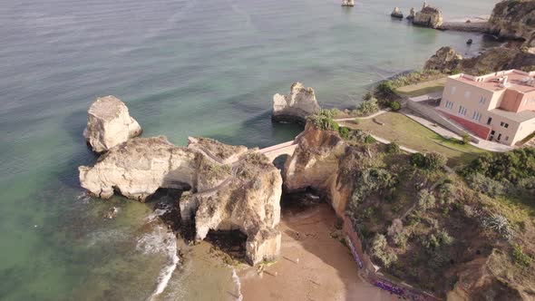 Aerial view of pont romain de Lagos, rock arch bridge at Praia dos Estudantes Algarve, Portugal. alt