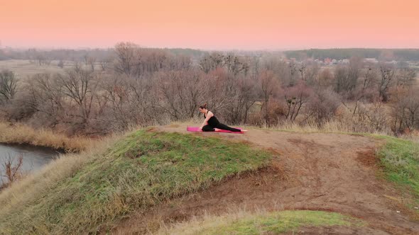 Young Woman Doing Yoga in Quiet Scenery