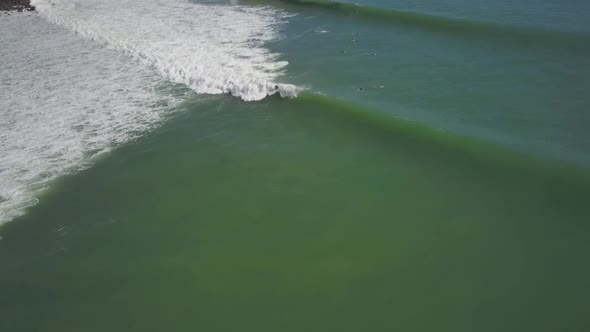 Aerial view of surfing waves in New Zealand