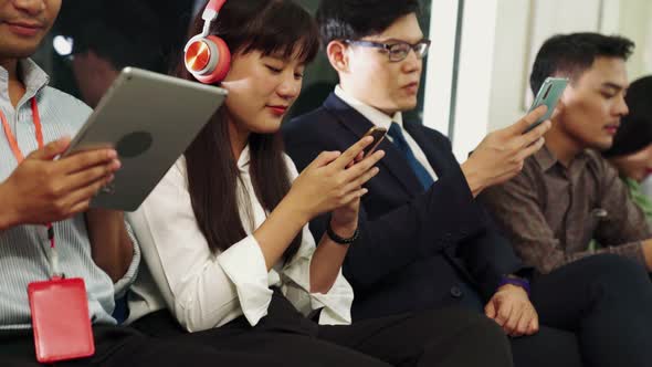 Young People Using Mobile Phone in Public Underground Train alt