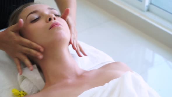 Woman Gets Facial and Head Massage in Luxury Spa alt