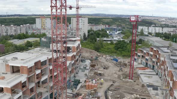 Construction of new apartments in a residential area,cranes,drone shot. alt