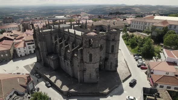 A marvellous gothic cathedral decorated with 2 bell towers is seen from the air - Guarda, Portugal.