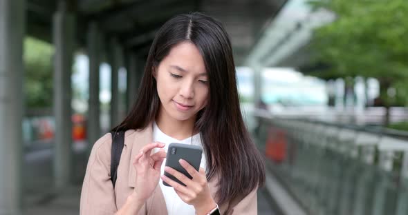 Woman use of mobile phone at outdoor alt