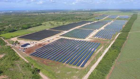 Aerial drone ascending pov over El Soco solar photovoltaic park of San Pedro De Macoris in Dominican alt