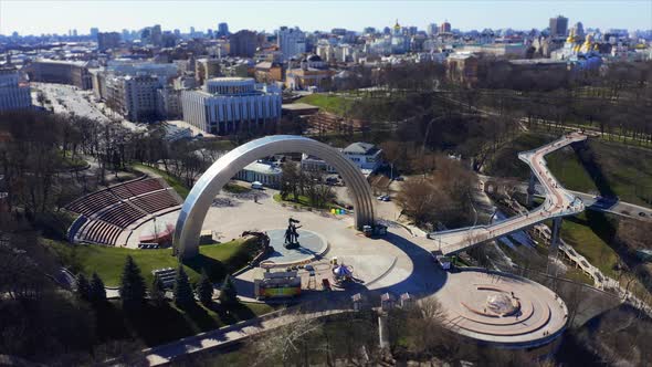 People Friendship Arch and Pedestrian Bridge of Klitschko. Reunion Arch in Kyiv, Ukraine. Aerial alt