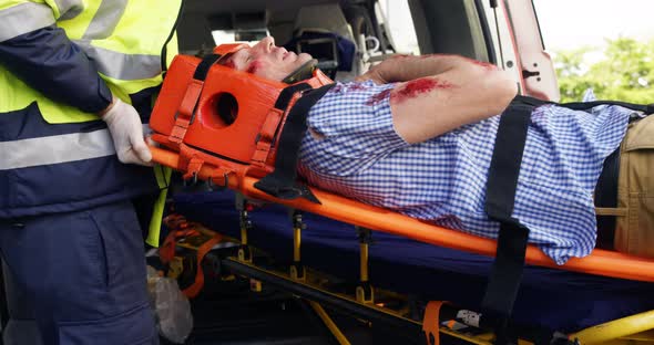 Emergency medical technicians holding a wounded person alt