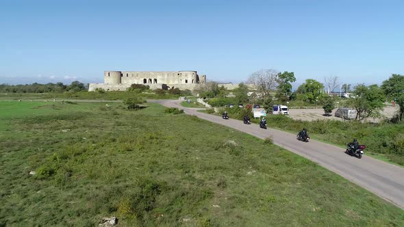 Aerial view of Borgholm Castle on the Isle of Oland in Sweden and group of motorcycles riding