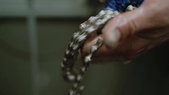 Crop Technician Washing Bicycle Chain