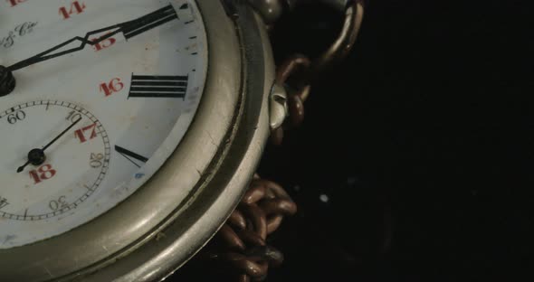 Macro shot of an antique pocket watch on a dark background alt