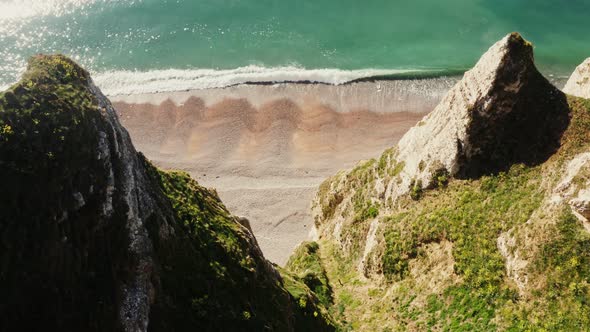 View From Above From the Top of a Cliff with Sharp Peaks to the Seashore alt
