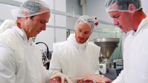 Male butcher maintaining records on clipboard alt