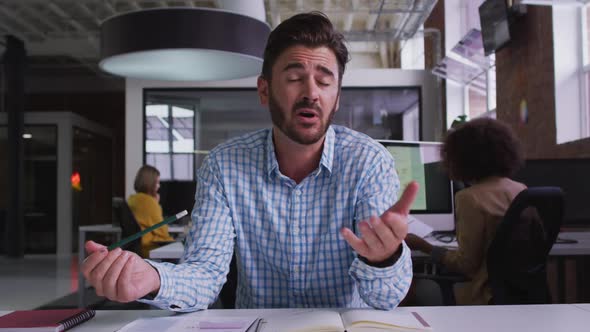 Happy caucasian businessman having video call sitting in front of computer alt