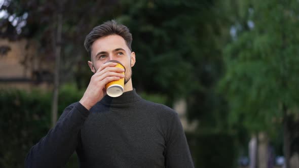 Smiling Handsome Man Drinking Morning Coffee Walking on Sunny City Street Leaving alt