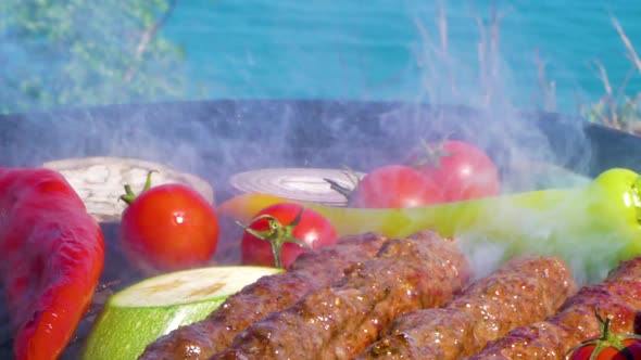 Grilling Kebabs With Vegetables On The Griil Plate, Turquoise Sea And Blu Sky On Background
