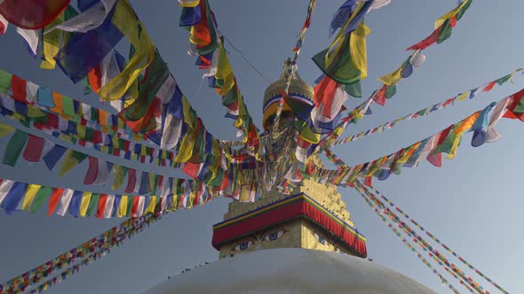 Prayer Flags at Boudhanath Stupa in Sunrise Lights, Kathmandu, Nepal, Crane Shot, UHD alt