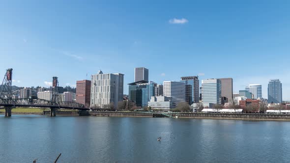 Portland Oregon downtown city skyline timelapse on a clear sunny day with few fast-moving clouds. alt