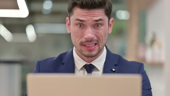 Close Up of Businessman Reacting To Loss on Laptop  alt