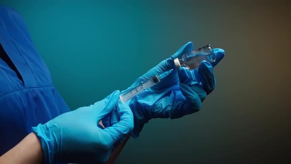 Doctor Filling Syringe with Solution alt