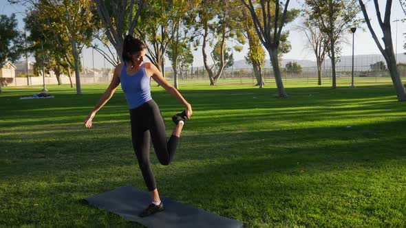 A young woman balancing and stretching before her yoga workout to stay healthy and prevent injury SL alt