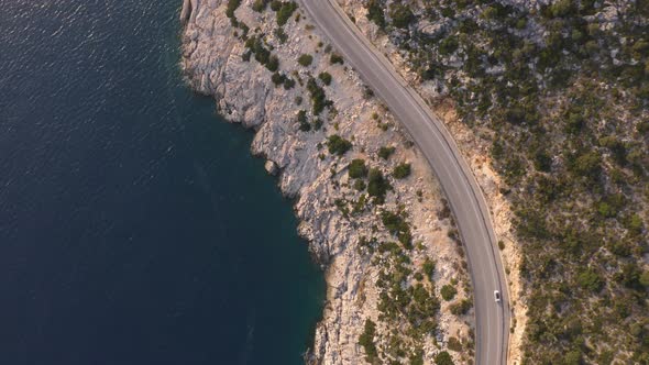 Aerial Drone View of Mountain Road Near the Turquoise Sea in Summer alt