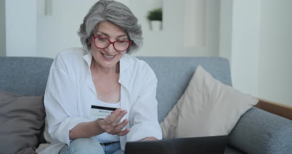 Senior Woman Wearing Glasses Spending Money in Internet Websites and Stores alt