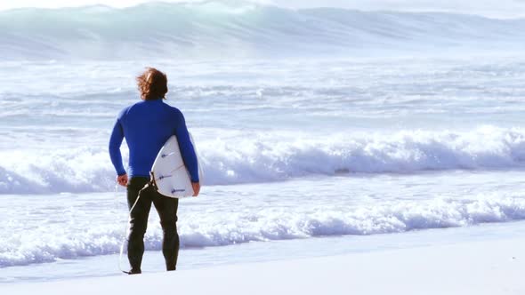 Surfer walking with surfboard alt
