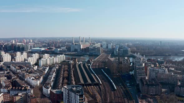 Circling drone shot over London railway tracks Battersea Power station Grosvenor bridge alt