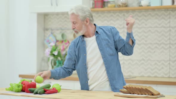 Happy Old Man Dancing in Kitchen alt