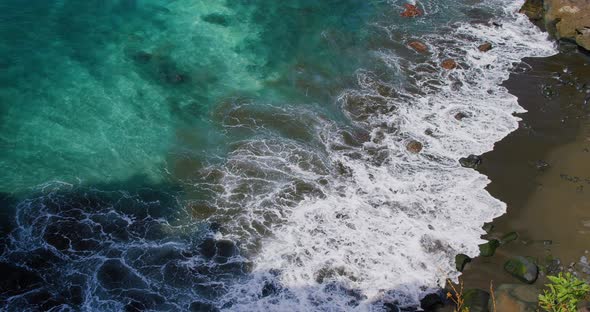 The Waves of the Ocean Break on the Rocky Shore alt