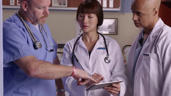 Medical professionals look at digital tablet together