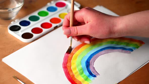 Woman draws rainbow. lgbt gay pride flag - lesbian, gay, bisexual, transgender social movements