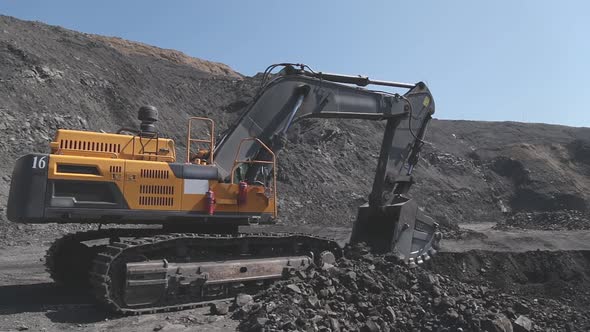 Excavator Digs on a Coal Mine