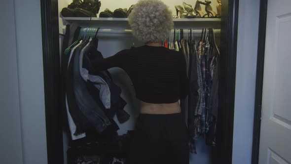 Transgender Woman Pushes Men's Clothes Away and Takes Women's Clothes alt
