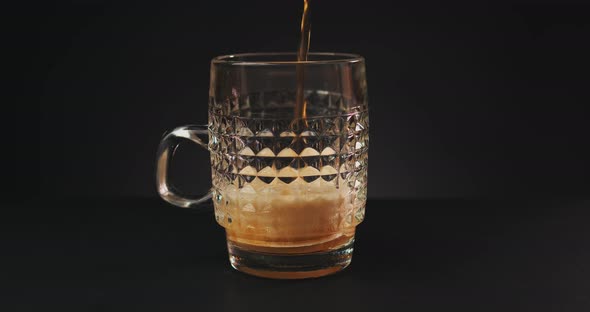 Pouring Beer Into Glass Over Dark Background alt