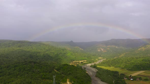 Rainbow in a Mountain Valley After Rain Top View alt