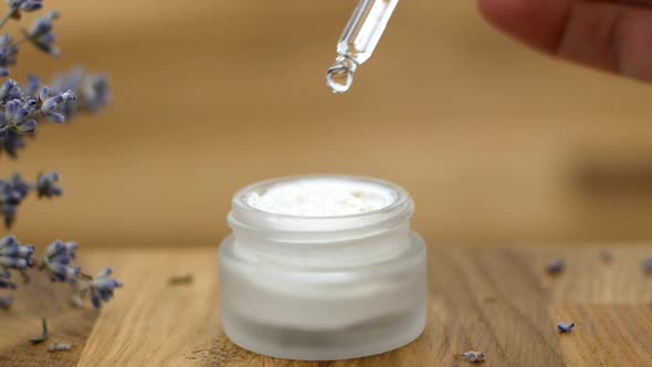 The oil drips from the dropper into the bottle. Cosmetic oils are based on natural ingredients.