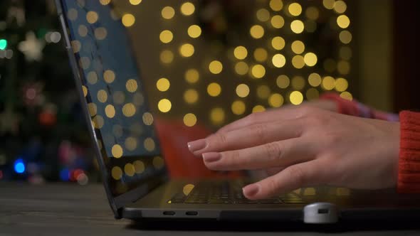 Woman Buys Gifts for Christmas and New Year Using Laptop