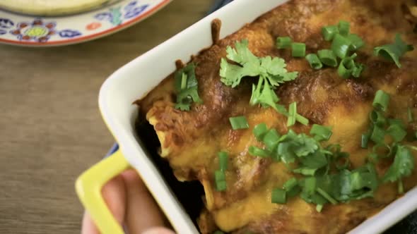 Chicken enchiladas with cheddar cheese and sauce. alt