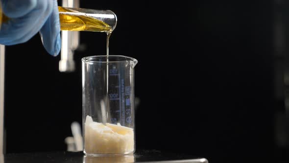 Cosmetics Manufacturing Industry. Close-up of Scientist in Gloves Testing Variety of Ingredients and alt