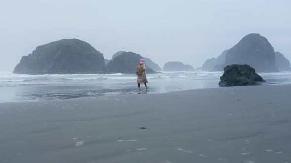 Scenic Drone Aerial Shot of Alone Attractive Woman Walking Oregon Coat Beach alt