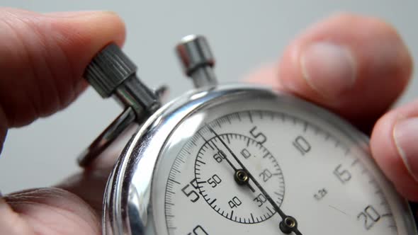 Old Stopwatch Mechanism in Man's Hand